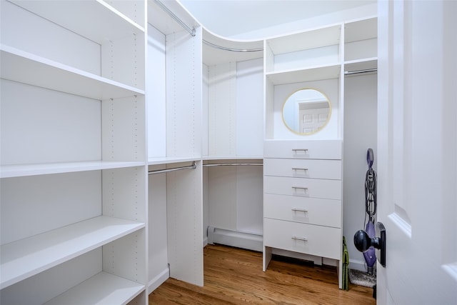 10 Bradish Ln, Babylon, NY 11702 - walk in closet with wood finished floors and a baseboard radiator