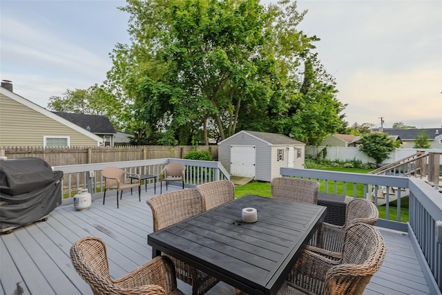 10 Bradish Ln, Babylon, NY 11702 - wooden terrace with a shed, a fenced backyard, outdoor dining space, and area for grilling
