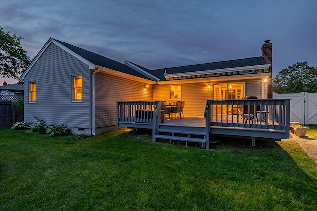 10 Bradish Ln, Babylon, NY 11702 - back of property at dusk featuring a chimney and a wooden deck