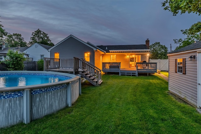10 Bradish Ln, Babylon, NY 11702 - rear view of property with a deck, a chimney, and a fenced backyard