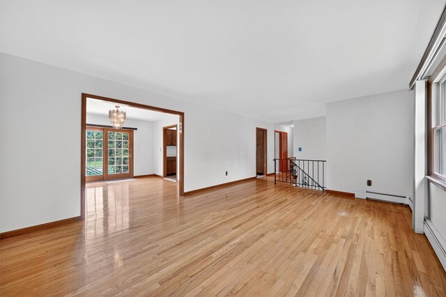169 Rte 118, Yorktown Heights, NY 10598 - empty room featuring baseboard heating, light wood-type flooring, and a chandelier