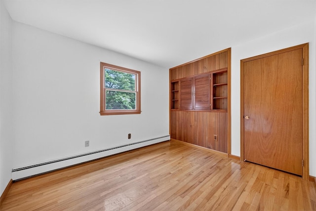 169 Rte 118, Yorktown Heights, NY 10598 - unfurnished bedroom featuring a baseboard radiator and light wood-type flooring