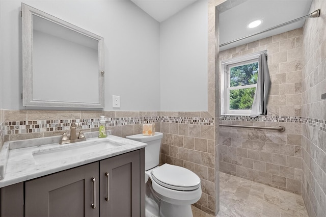 169 Rte 118, Yorktown Heights, NY 10598 - full bathroom with vanity, tile walls, tiled shower, and a wainscoted wall