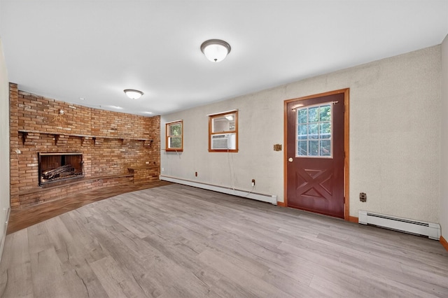 169 Rte 118, Yorktown Heights, NY 10598 - unfurnished living room with baseboard heating, wood finished floors, and a brick fireplace