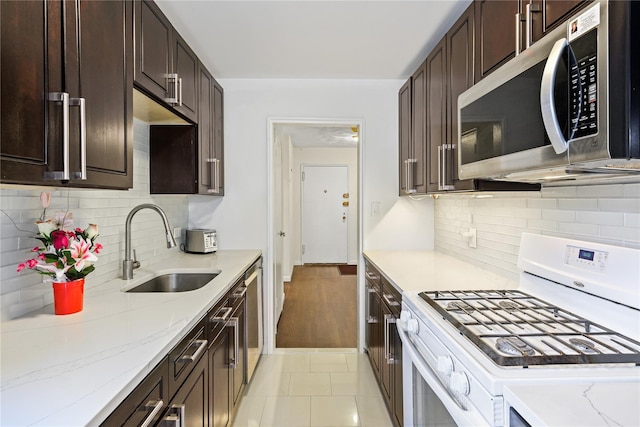 18-40 211th St Unit 4E, Bayside, NY 11360 - kitchen with stainless steel appliances, a sink, and dark brown cabinetry