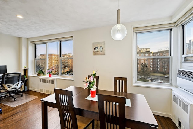 18-40 211th St Unit 4E, Bayside, NY 11360 - dining area with radiator heating unit, wood finished floors, a view of city, and a desk