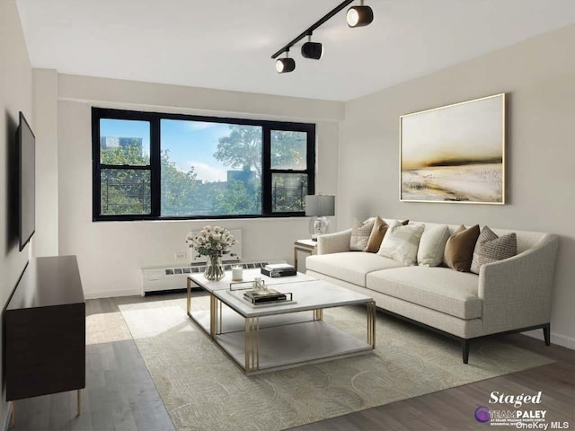 83-60 118th St Unit 7K, Kew Gardens, NY 11415 - living room with wood finished floors, rail lighting, and baseboard heating
