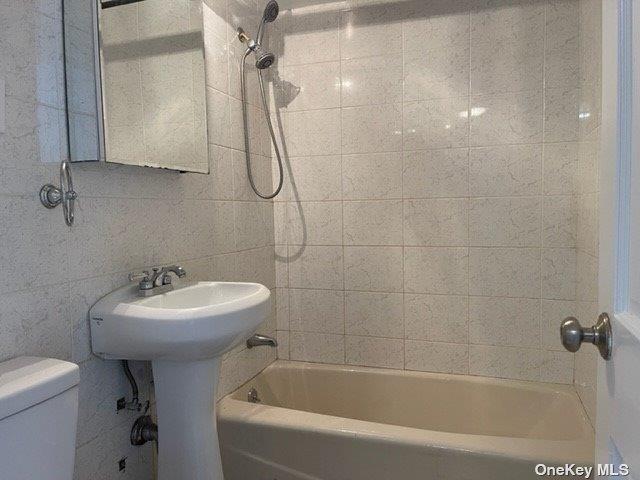 83-60 118th St Unit 7K, Kew Gardens, NY 11415 - bathroom featuring toilet and shower / washtub combination