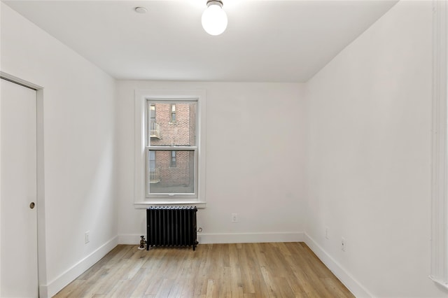 1180 Grant Ave, Bronx, NY 10456 - unfurnished room featuring radiator heating unit, baseboards, and light wood-type flooring