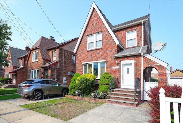 95-15 243rd St, Floral Park, NY 11001 - tudor-style house with brick siding and roof with shingles