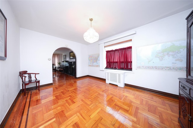 95-15 243rd St, Floral Park, NY 11001 - unfurnished room featuring radiator heating unit, arched walkways, a chandelier, and baseboards
