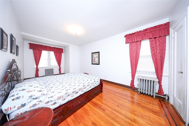 95-15 243rd St, Floral Park, NY 11001 - bedroom with light wood-style flooring and radiator heating unit