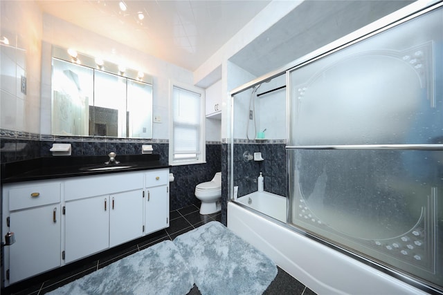 95-15 243rd St, Floral Park, NY 11001 - bathroom with tile walls, vanity, toilet, enclosed tub / shower combo, and a wainscoted wall