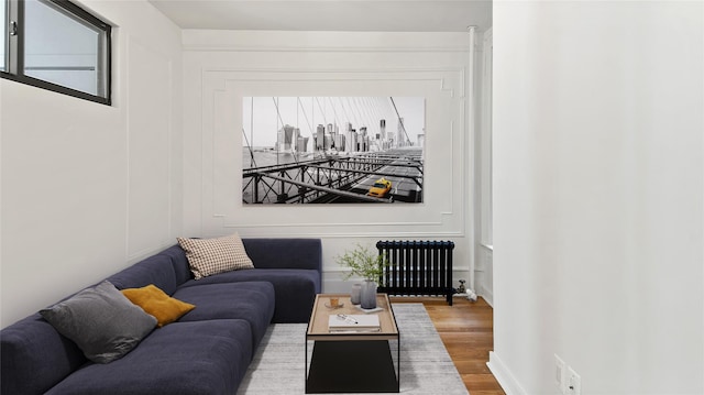 1037 College Ave, Bronx, NY 10456 - living area with radiator heating unit and wood finished floors
