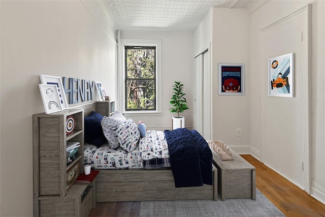 1037 College Ave, Bronx, NY 10456 - bedroom featuring wood-type flooring and baseboards