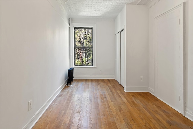 1037 College Ave, Bronx, NY 10456 - unfurnished bedroom featuring light wood-style floors and baseboards
