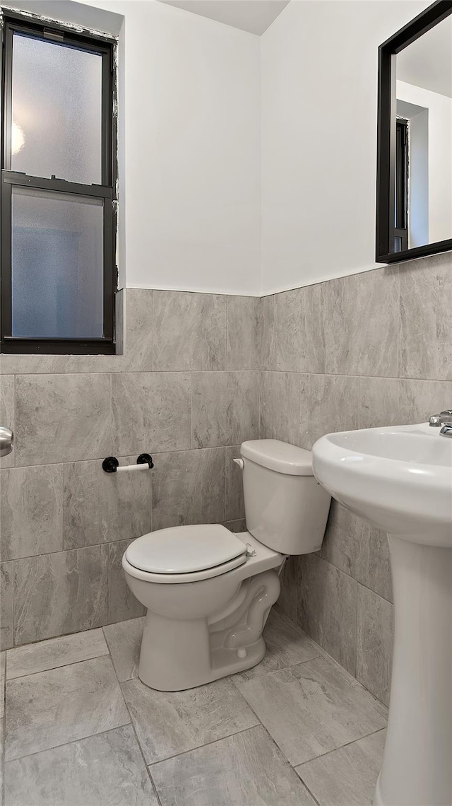1037 College Ave, Bronx, NY 10456 - half bath featuring toilet, tile walls, and a wainscoted wall