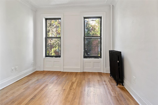 1037 College Ave, Bronx, NY 10456 - unfurnished room featuring plenty of natural light, light wood-style flooring, radiator heating unit, and baseboards
