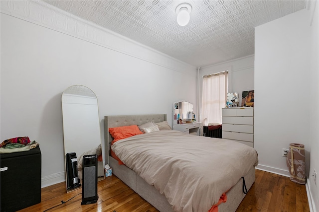 1037 College Ave, Bronx, NY 10456 - bedroom with hardwood / wood-style flooring, an ornate ceiling, and baseboards