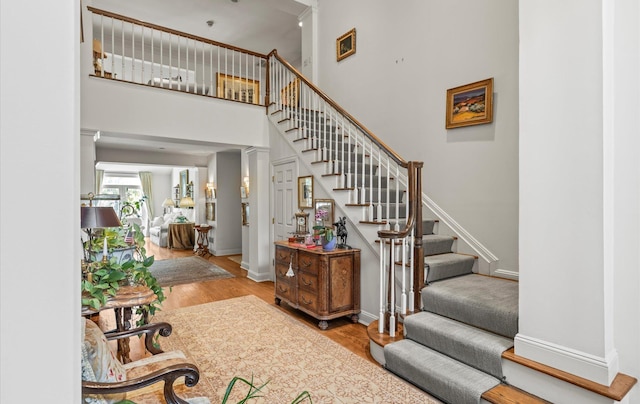 5 Hickory Ct, Manhasset, NY 11030 - stairway with wood finished floors, baseboards, and a high ceiling