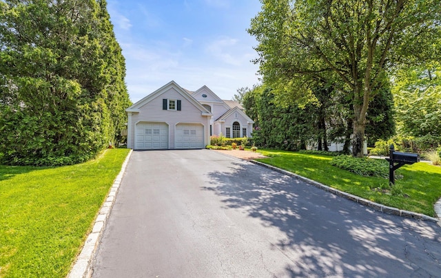5 Hickory Ct, Manhasset, NY 11030 - view of front of home featuring driveway, a garage, and a front yard