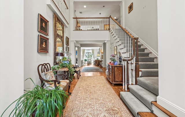 5 Hickory Ct, Manhasset, NY 11030 - entrance foyer featuring wood finished floors, stairway, and a towering ceiling