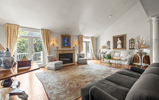 5 Hickory Ct, Manhasset, NY 11030 - living area featuring wood finished floors, a fireplace with flush hearth, lofted ceiling, and ornate columns