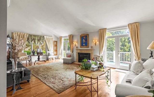 5 Hickory Ct, Manhasset, NY 11030 - living room featuring a fireplace with flush hearth, wood finished floors, french doors, and lofted ceiling