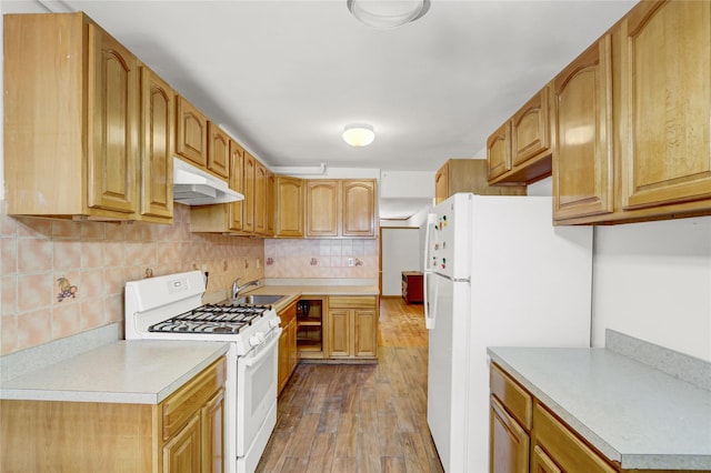 1327 E 84th St, Brooklyn, NY 11236 - kitchen with white appliances, under cabinet range hood, a sink, dark wood-style floors, and light countertops