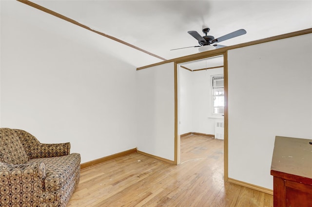 1327 E 84th St, Brooklyn, NY 11236 - living area with radiator heating unit, light wood-style floors, ceiling fan, and baseboards