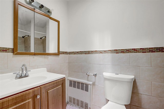 1327 E 84th St, Brooklyn, NY 11236 - bathroom with radiator heating unit, vanity, toilet, tile walls, and a tile shower