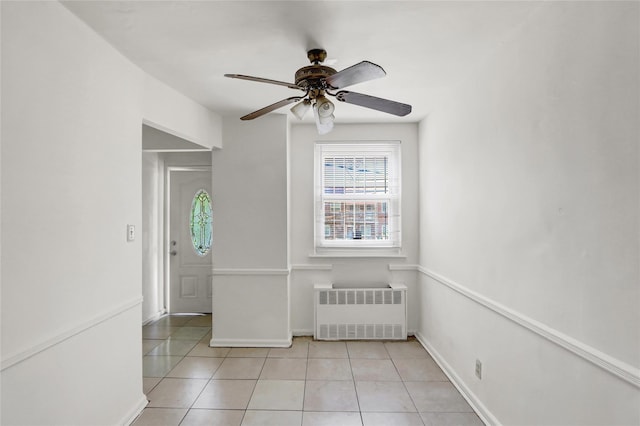1327 E 84th St, Brooklyn, NY 11236 - empty room with radiator heating unit, a ceiling fan, light tile patterned floors, and baseboards