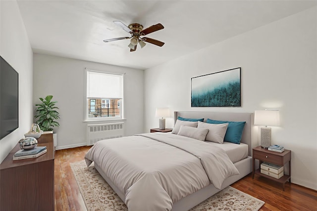 1327 E 84th St, Brooklyn, NY 11236 - bedroom with radiator heating unit, wood finished floors, and baseboards