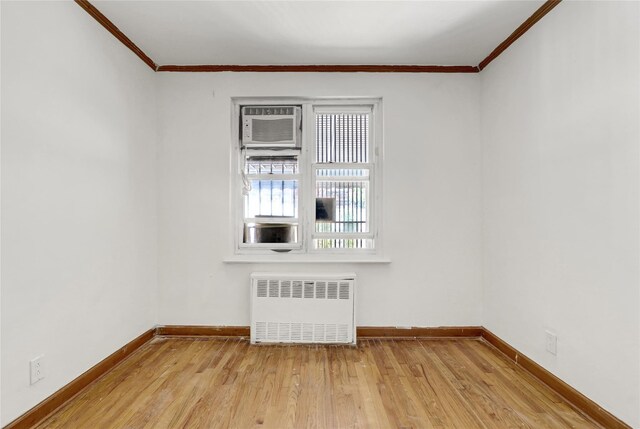 1327 E 84th St, Brooklyn, NY 11236 - unfurnished room with radiator, wood finished floors, ornamental molding, and baseboards