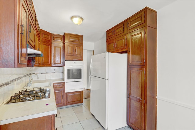 1327 E 84th St, Brooklyn, NY 11236 - kitchen featuring white appliances, a sink, a warming drawer, light countertops, and under cabinet range hood