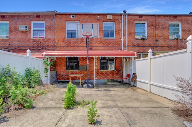 1327 E 84th St, Brooklyn, NY 11236 - rear view of property featuring brick siding, an AC wall unit, and cooling unit