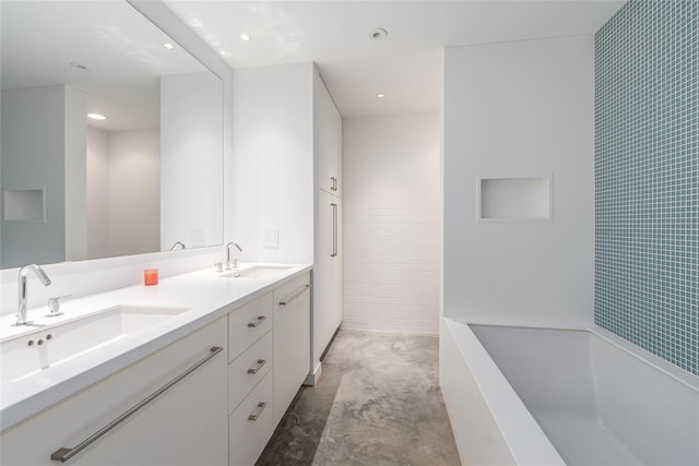 470 Lloyds Ln, Mattituck, NY 11952 - full bathroom with a tub to relax in, double vanity, unfinished concrete floors, and recessed lighting