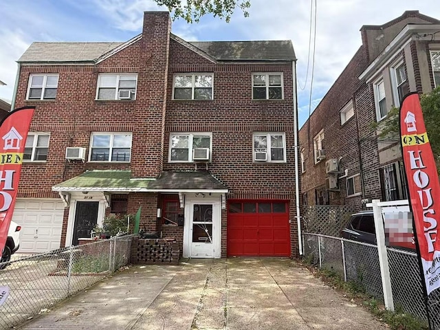 51-21 Goldsmith St, Elmhurst, NY 11373 - view of front of house with a garage, a chimney, concrete driveway, brick siding, and cooling unit