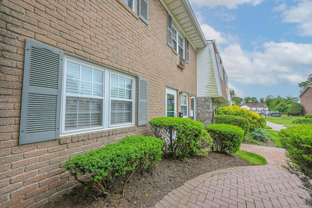 42 Springwood Dr, North Babylon, NY 11703 - view of side of property featuring stone siding and brick siding
