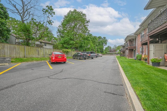 42 Springwood Dr, North Babylon, NY 11703 - uncovered parking lot with a residential view