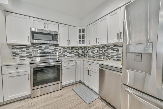 42 Springwood Dr, North Babylon, NY 11703 - kitchen featuring appliances with stainless steel finishes, a sink, light countertops, and white cabinets