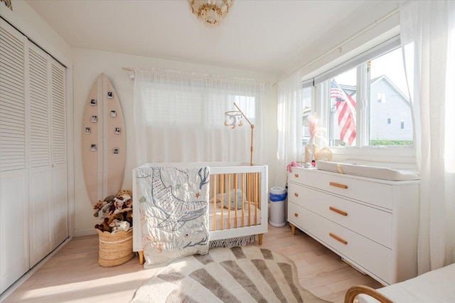 96 Alabama St, Long Beach, NY 11561 - bedroom featuring light wood-type flooring, a closet, and a nursery area