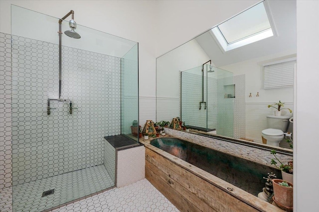 96 Alabama St, Long Beach, NY 11561 - bathroom featuring a skylight, walk in shower, toilet, a bath, and tile walls