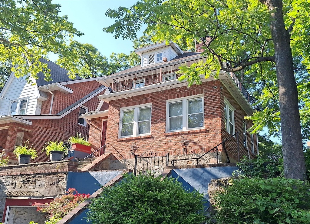 26 Amsterdam Pl, Mount Vernon, NY 10553 - traditional style home featuring brick siding, a chimney, and stairway