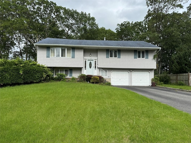 71 Harvest Ln, West Islip, NY 11795 - split foyer home featuring asphalt driveway, a garage, and roof with shingles