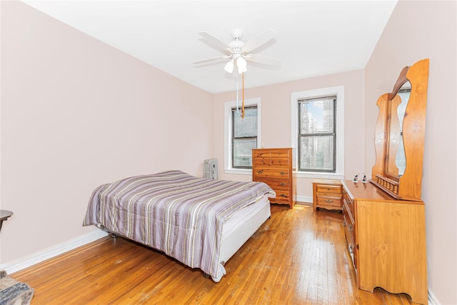 2187 Holland Ave Unit 2J, Bronx, NY 10462 - bedroom with light wood finished floors, radiator heating unit, and a ceiling fan