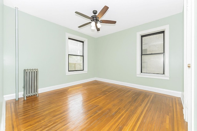 2187 Holland Ave Unit 2J, Bronx, NY 10462 - spare room featuring radiator, hardwood / wood-style flooring, and ceiling fan