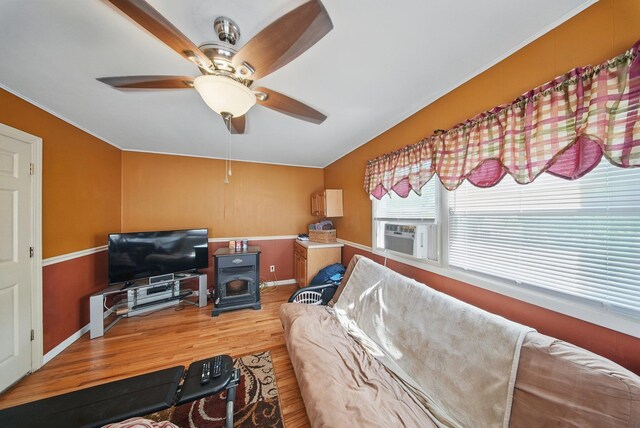 482 Scotchtown Ave, Middletown, NY 10941 - living area featuring a wood stove, wood finished floors, a ceiling fan, and cooling unit