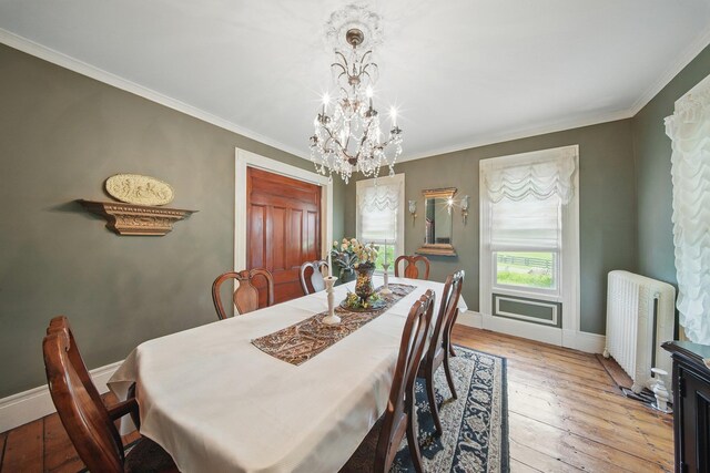 482 Scotchtown Ave, Middletown, NY 10941 - dining area with radiator heating unit, a chandelier, light wood finished floors, and crown molding