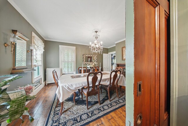 482 Scotchtown Ave, Middletown, NY 10941 - dining area with radiator heating unit, a chandelier, wood-type flooring, and crown molding